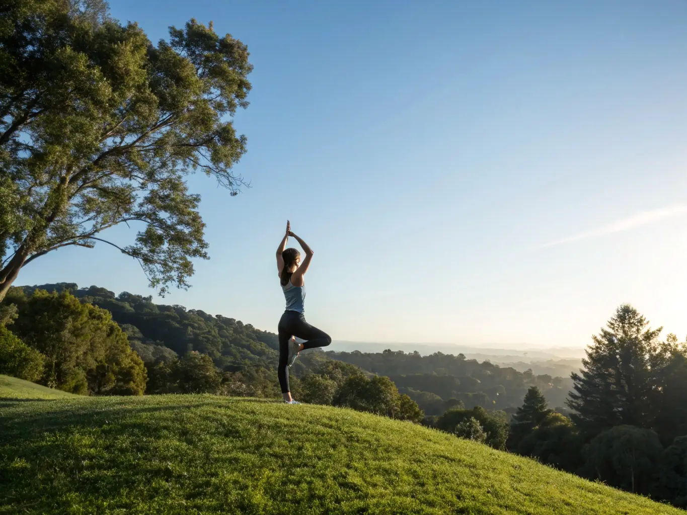 A serene image of a woman in her 40s practicing yoga outdoors at sunrise, symbolizing physical and mental well-being.